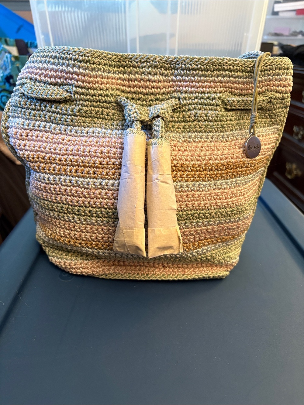 The Sak Crochet Drawstring Tote in Olive Green & Blush Pink